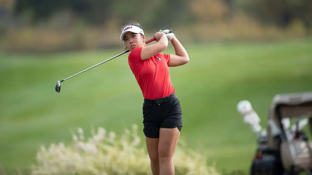 Female golfer swinging a club